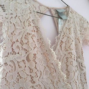 Pink calf-length lace dress.